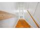 Bright staircase showcasing hardwood steps and white walls leading to a white door at 1433 Carroll Drive Nw, Unit #3, Atlanta, GA 30318