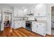 Well-equipped kitchen with white cabinetry, stainless steel appliances, and a view of the breakfast area at 6009 Wyndham Woods Dr, Powder Springs, GA 30127
