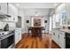 Bright kitchen with breakfast bar, modern appliances, and a cozy eat-in area with nature views at 6009 Wyndham Woods Dr, Powder Springs, GA 30127