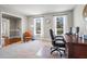 Bright office with neutral walls, two windows with white curtains, and a dark wooden desk at 6009 Wyndham Woods Dr, Powder Springs, GA 30127