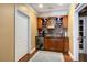 Bar area with wooden cabinets, mosaic backsplash, mini-fridge, and hardwood floors at 5136 Heron Bay Blvd, Locust Grove, GA 30248