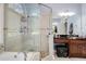 Well-lit bathroom featuring a separate glass shower, soaking tub, and vanity at 5136 Heron Bay Blvd, Locust Grove, GA 30248