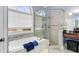 Bathroom featuring a separate glass shower, soaking tub and stone accents at 5136 Heron Bay Blvd, Locust Grove, GA 30248