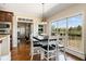 Dining area with wood floors, view to large back yard and view into living spaces at 5136 Heron Bay Blvd, Locust Grove, GA 30248