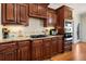 Kitchen boasts stainless steel appliances, dark wood cabinets, and granite countertops at 5136 Heron Bay Blvd, Locust Grove, GA 30248