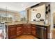 Kitchen island with dark wood cabinets, granite countertops, and stainless steel appliances at 5136 Heron Bay Blvd, Locust Grove, GA 30248