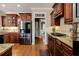Kitchen boasts stainless steel appliances, dark wood cabinets, and granite countertops at 5136 Heron Bay Blvd, Locust Grove, GA 30248