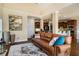 Comfortable living room featuring hardwood flooring, with a view into the kitchen area and a vaulted ceiling at 5136 Heron Bay Blvd, Locust Grove, GA 30248