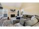 Cozy living room featuring vaulted ceiling, fireplace, plush seating, and ample natural light at 5136 Heron Bay Blvd, Locust Grove, GA 30248