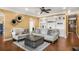 Elegant living room featuring hardwood floors, built-in bookshelves, and comfortable seating at 5136 Heron Bay Blvd, Locust Grove, GA 30248