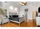 Spacious main bedroom features hardwood floors, tray ceiling, and stylish furnishings at 5136 Heron Bay Blvd, Locust Grove, GA 30248