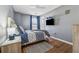 Cozy bedroom with a patterned bedspread, ceiling fan, hardwood floors, and a closet at 880 Hillary Ln, Lawrenceville, GA 30043