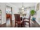 Dining room with hardwood floors, a glass top table, wainscoting, and view into kitchen at 880 Hillary Ln, Lawrenceville, GA 30043