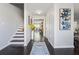 Bright foyer with hardwood floors, staircase, neutral walls, and view into other living spaces at 880 Hillary Ln, Lawrenceville, GA 30043