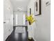Welcoming foyer with hardwood floors, art accents, white walls, and a glimpse of the front door at 880 Hillary Ln, Lawrenceville, GA 30043
