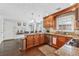 Kitchen featuring wooden cabinets, stainless steel appliances, granite counters and breakfast area at 880 Hillary Ln, Lawrenceville, GA 30043
