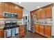 Well-lit kitchen features stainless steel appliances, dark wood floors, granite countertops, and ample storage at 880 Hillary Ln, Lawrenceville, GA 30043
