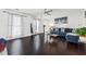 Open-concept living area featuring hardwood floors, large windows, and stylish contemporary furnishings at 880 Hillary Ln, Lawrenceville, GA 30043