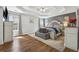Spacious main bedroom featuring a trey ceiling, hardwood floors, and natural light from the window at 880 Hillary Ln, Lawrenceville, GA 30043