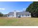 Spacious backyard showcasing a well-maintained lawn and rear exterior of the home with neutral siding at 895 Burton Ridge Dr, Loganville, GA 30052