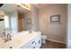 Bright bathroom with double sinks, large mirror and neutral decor at 895 Burton Ridge Dr, Loganville, GA 30052