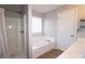 Well-lit bathroom features a shower, soaking tub, and contemporary fixtures at 895 Burton Ridge Dr, Loganville, GA 30052