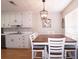 Bright dining area with adjacent kitchen and white cabinetry at 895 Burton Ridge Dr, Loganville, GA 30052