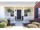 Inviting covered front porch with decorative plants, offering a welcoming entrance to the home at 895 Burton Ridge Dr, Loganville, GA 30052