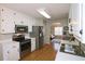 Modern kitchen featuring white cabinets, stainless steel appliances, and an open layout at 895 Burton Ridge Dr, Loganville, GA 30052