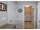 View of the laundry room with a washer and dryer, storage shelves, and neutral paint at 895 Burton Ridge Dr, Loganville, GA 30052