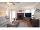 Comfortable living room with a brick fireplace, hardwood floors, and stylish decor, perfect for relaxing at 895 Burton Ridge Dr, Loganville, GA 30052