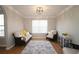 Inviting living room features neutral walls, hardwood floors and modern lighting at 895 Burton Ridge Dr, Loganville, GA 30052