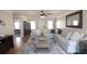 Spacious living room featuring hardwood floors, a large sofa, and an open floorplan at 895 Burton Ridge Dr, Loganville, GA 30052