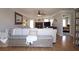 Spacious living room with hardwood floors, a large sectional sofa, and an open layout to other rooms at 895 Burton Ridge Dr, Loganville, GA 30052