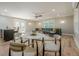 Entertaining in the basement with modern bar, marble table and chairs, with stylish black leather couch at 4446 Huntington Cir, Atlanta, GA 30338