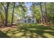 Spacious front yard showcasing a two-story home with traditional shutters and a covered entry at 4446 Huntington Cir, Atlanta, GA 30338