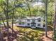 Aerial view of a beautiful two-story home surrounded by mature trees and a well-kept lawn at 4446 Huntington Cir, Atlanta, GA 30338