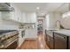 Bright kitchen featuring stainless steel appliances, gold hardware, and hardwood floors at 4446 Huntington Cir, Atlanta, GA 30338
