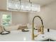 Close-up of a well-appointed kitchen island with a modern faucet and stylish lighting, perfect for meal prep at 4446 Huntington Cir, Atlanta, GA 30338