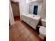 Bathroom featuring double sinks, tile flooring, a walk-in closet, and a separate toilet area at 523 Lantern Wood Dr, Scottdale, GA 30079