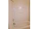 Standard white bathtub and shower combo with a simple design for functional bathroom space at 523 Lantern Wood Dr, Scottdale, GA 30079