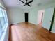 Bright bedroom with hardwood flooring, a ceiling fan, and natural light at 523 Lantern Wood Dr, Scottdale, GA 30079