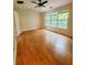 Bright bedroom with hardwood flooring, a ceiling fan, and natural light at 523 Lantern Wood Dr, Scottdale, GA 30079