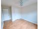 Bright bedroom with wood laminate flooring, a ceiling fan, and neutral colored walls at 523 Lantern Wood Dr, Scottdale, GA 30079