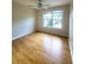 Spacious bedroom featuring hardwood floors, a ceiling fan, and a bright window at 523 Lantern Wood Dr, Scottdale, GA 30079