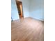 Clean bedroom with wood laminate flooring and neutral colored walls and a large closet at 523 Lantern Wood Dr, Scottdale, GA 30079