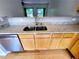 Close-up of granite countertops with stainless steel sink and wooden cabinets at 523 Lantern Wood Dr, Scottdale, GA 30079