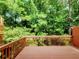 Spacious wooden deck surrounded by lush green trees offering serene outdoor living at 523 Lantern Wood Dr, Scottdale, GA 30079