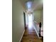 Hallway featuring hardwood floors and a view of another room at 523 Lantern Wood Dr, Scottdale, GA 30079