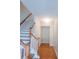 Bright hallway with wood floors and stairs leading up, featuring a closet for storage at 523 Lantern Wood Dr, Scottdale, GA 30079